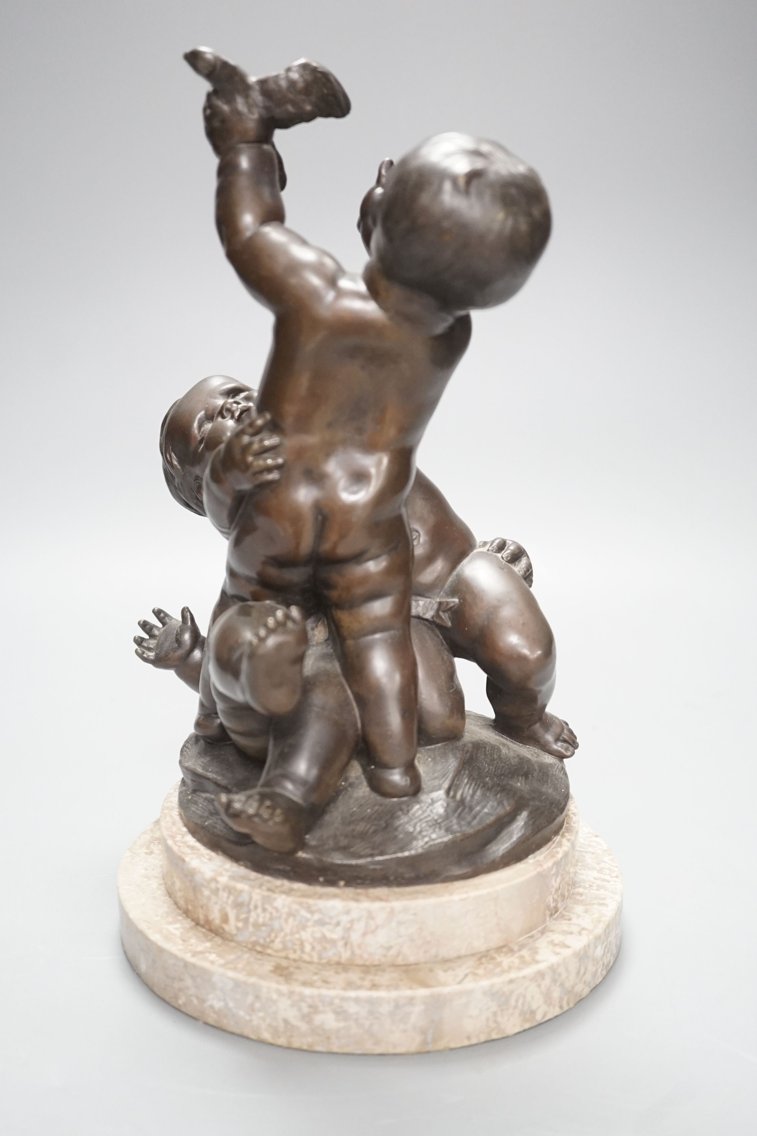 A bronze figure group of a trio of putto, height 28cm